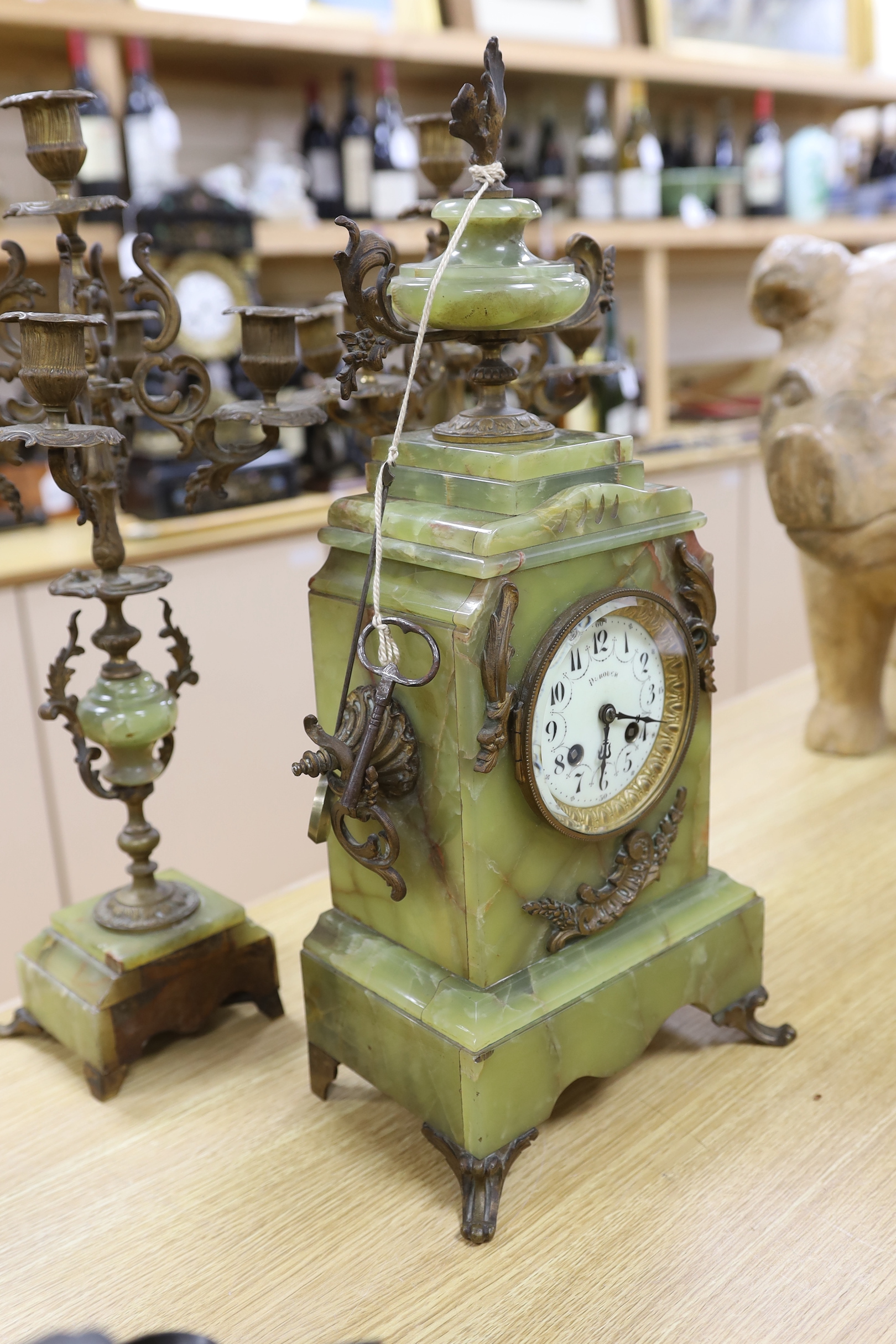 A French green onyx and bronze clock garniture, early 20th century, clock 50cm high